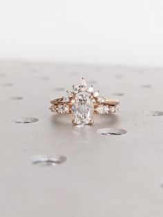 a white diamond ring sitting on top of a table