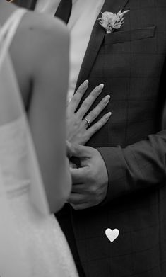 the bride and groom are holding their hands close together as they stand next to each other