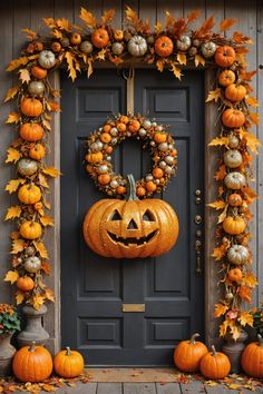 a front door decorated for halloween with pumpkins and wreath