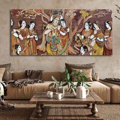 a living room with couches and paintings on the wall