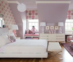 a bedroom with purple walls and white furniture