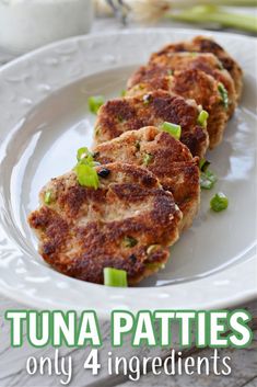 tuna patties on a white plate with green onions