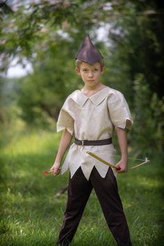 a young boy dressed in an ancient costume