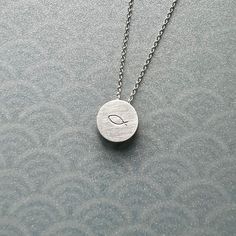 This custom necklace with the stamped fish is perfect to wear every day. The pendant is double faced, so you can wear it with the plain side showing or with the fish symbol in the front. It is also possible to get an  initial or another design on the back, please contact me for options. The silver necklace is a great gift for the first communion, or as a symbolic gift for a baptism showcasing the christian fish symbol. even  Choose the perfect length for you from variations and decide if you wan Christian Fish Symbol, Cable Jewelry, Large Locket, Fish Symbol, Minimalist Pendant, Silver Lockets, Custom Necklace, Double Face, Wedding Necklace