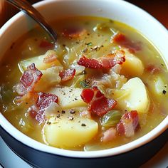 a bowl of soup with potatoes and bacon