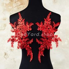 a black mannequin with red flowers on it