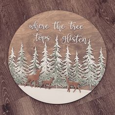 a wooden sign that says, where the tree tops are glisten and two deers