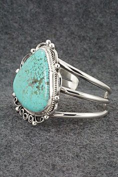 This stunning turquoise and sterling silver bracelet was made by Navajo silversmith Leslie Nez. The back is signed Leslie Nez and Sterling.Size: 5 5/8" (will fit up to a 6 7/8" wrist)Gap: 1 1/4"Width: 2 1/4"Free shipping on all orders! We ship with USPS and always include tracking. All orders ship within a day of payment.Returns are accepted up to 30 days after you receive your order. Just send us a message. Our shop offers cash back or store credit. The item must be returned in new condition. Elegant Sterling Silver Bracelet With Turquoise, Adjustable Southwestern Sterling Silver Bracelet With Turquoise, Elegant Turquoise Sterling Silver Oyster Bracelet, Adjustable Southwestern Turquoise Sterling Silver Bracelet, Adjustable Turquoise Sterling Silver Bracelet In Southwestern Style, Unique Turquoise Sterling Silver Bracelets, Bohemian Turquoise Sterling Silver Cuff Bracelet, Southwestern Turquoise Sterling Silver Cuff Bracelet, Western Style Sterling Silver Bangle