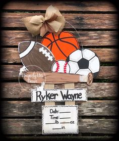 a wooden sign with a basketball, ball and bat on it