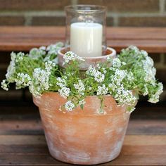 a candle is sitting in a flower pot