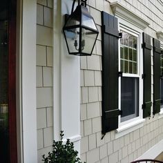 an outside view of a house with chairs and windows