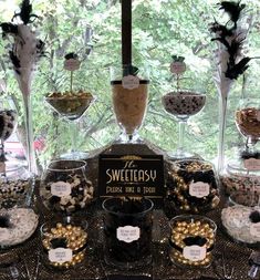 a table topped with lots of desserts and wine glasses filled with chocolate covered treats