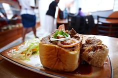 a plate with some food on it and people in the background at a restaurant table