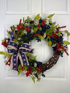 a patriotic wreath with red, white and blue flowers