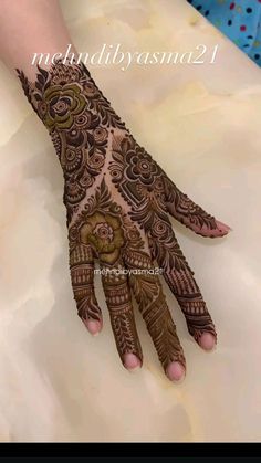 the hand is decorated with henna designs