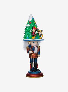 a nutcracker figurine with a christmas tree on top