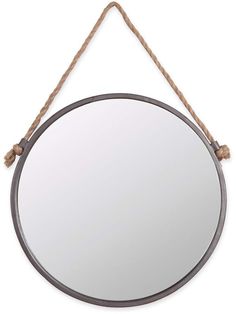 a round mirror hanging on a rope