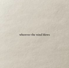 the words are written in black on a white paper background, and it says, wherever the wind blows