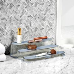 a marble bathroom counter top with two shelves holding personal care items