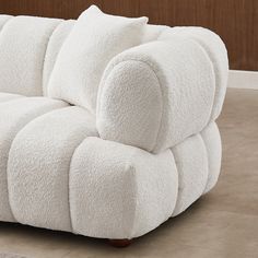 a white couch sitting on top of a tiled floor