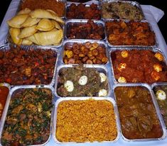 a table topped with trays filled with different types of food