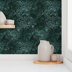 a teal green wallpaper with white vases and cups on a shelf in front of it