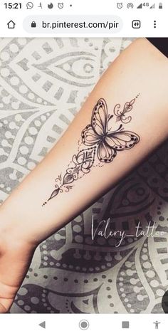 a woman's arm with a butterfly tattoo on the left side of her arm