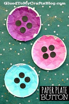 three paper plates with buttons on them sitting on a green surface and stars in the background