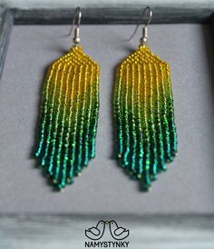 These green seed bead earrings are made of high-quality Czech beads and strong synthetic thread. They are elegant, fashionable, and highly versatile, suitable for everyday wear. Features: Sterling silver components Color: yellow, green, emerald. This item is currently in stock. You must be completely satisfied. If you find merchandise unsatisfactory for any reason, return it within 10 days and your money will be refunded without questions. More beaded earrings http://etsy.me/2ycItdb Gerdan neckl Green Beaded Chain Earrings With Round Beads, Green Earrings With Beaded Chain And Round Beads, Green Dangle Earrings With Beaded Chain, Green Beaded Fringe Jewelry For Summer, Green Dangle Chandelier Earrings For Summer, Summer Green Dangle Chandelier Earrings, Green Tassel Drop Earrings With Colorful Beads, Green Beaded Earrings With Fringe For Summer, Green Faceted Bead Dangle Earrings