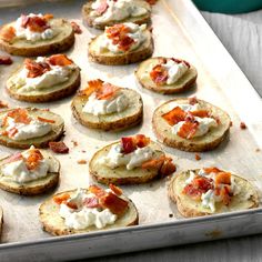 a tray filled with crackers covered in cream cheese and bacon