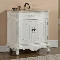 a white bathroom sink sitting under a mirror next to a wooden floor and pink wall