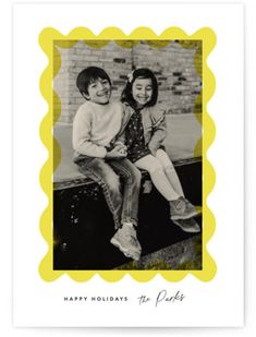 a black and white photo of two children sitting on a bench with the words happy holidays to you