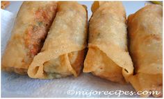 three fried food items sitting on top of white paper