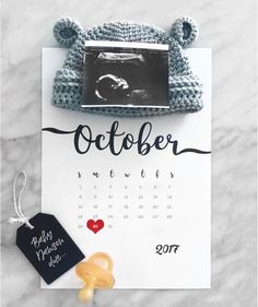 a calendar with a teddy bear on it next to a black and white photo frame