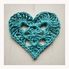 a crocheted heart is shown in the middle of an instagramtion page