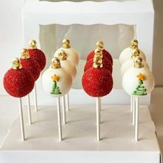 four white and red cake pops decorated with christmas decorations