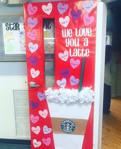 a door decorated with paper hearts and writing that says we love you a latte