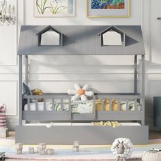 a child's bedroom with a gray bunk bed and toys on the floor in front of it