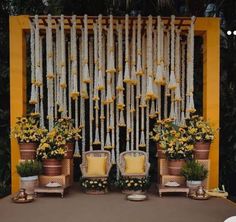 a decorated stage with chairs and flowers