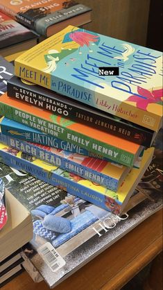 a stack of books sitting on top of a wooden table