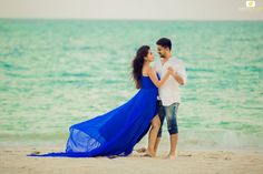 a man and woman dancing on the beach