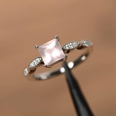 It is a natural pink quartz ring, princess cut, measures 6mm*6mm, weight about 1.03 cts. The basic metal is sterling silver and plated with rhodium. To change the metal to a solid gold (white/rose) or platinum is also available, please ask for a quotation if you want. You can also go to my shop Home for more elegant rings: https://www.etsy.com/shop/godjewelry?ref=hdr_shop_menu More pink quartz rings: https://www.etsy.com/shop/godjewelry?ref=seller-platform-mcnav&section_id=22545141 Customiza Square Cut Engagement Rings, Pink Quartz Ring, Rings Princess, Pink Gemstone Ring, Elegant Rings, Square Engagement Rings, Pink Morganite Engagement Ring, Pink Engagement Ring, Swiss Blue Topaz Ring