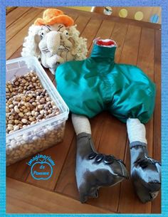 a stuffed animal is laying on the floor next to some nuts and other things that are in plastic containers