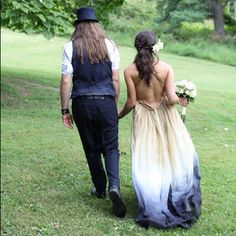 a man and woman walking in the grass