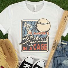 a t - shirt that says, my son is raised in a cage with a baseball bat and ball