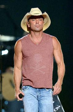 a man wearing a cowboy hat and jeans