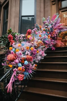 a bunch of flowers that are sitting on some steps