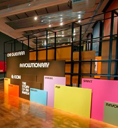 an empty room with many different colored sticky notes on the wall and wooden flooring