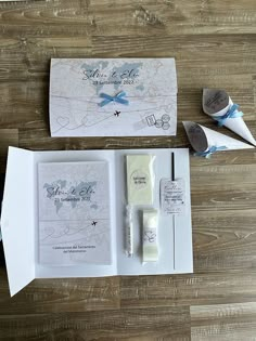 the wedding stationery is laid out on top of the wooden floor and ready to be used