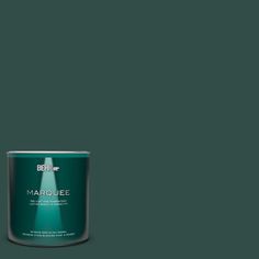 a can of behr marquee paint on a green background